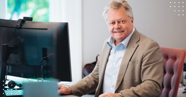 Photo of man in front of computer in office